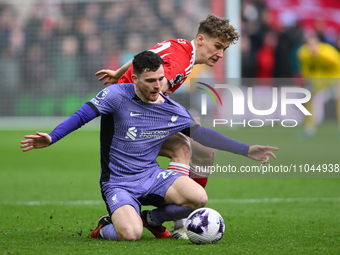 Ryan Yates is battling with Andrew Robertson of Liverpool during the Premier League match between Nottingham Forest and Liverpool at the Cit...