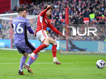 Neco Williams of Nottingham Forest is battling with Andrew Robertson of Liverpool during the Premier League match between Nottingham Forest...
