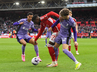 Divock Origi of Nottingham Forest is under pressure from Cody Gakpo and Bobby Clark of Liverpool during the Premier League match between Not...