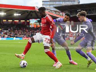 Divock Origi of Nottingham Forest is under pressure from Cody Gakpo and Bobby Clark of Liverpool during the Premier League match between Not...