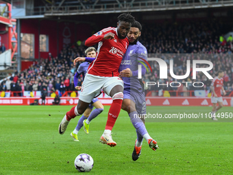 Divock Origi of Nottingham Forest is battling with Joe Gomez of Liverpool during the Premier League match between Nottingham Forest and Live...