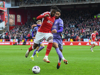Divock Origi of Nottingham Forest is battling with Joe Gomez of Liverpool during the Premier League match between Nottingham Forest and Live...