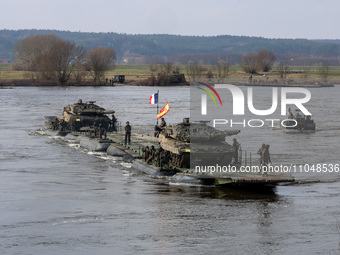 France and Spain flagged servicemen exercise ability to cross armored vehicles through Vistula river on ferries during NATO's  Dragon-24 exe...