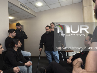 Iranian singer Reza Sadeghi (C) is speaking with his band before performing in a live concert for child laborers at the Tehran Milad Tower C...