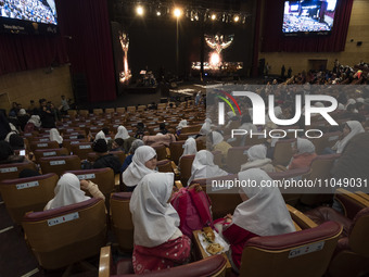 Child laborers are sitting in a concert hall before the start of a live concert at the Tehran Milad Tower Cultural and Recreational Complex...