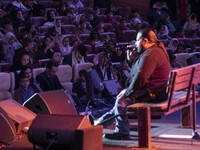 Iranian singer Reza Sadeghi (R) is performing during a live concert for child laborers at the Tehran Milad Tower Cultural and Recreational C...