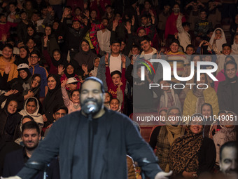 Iranian singer Reza Sadeghi is posing for a photograph with child laborers during a live concert at the Tehran Milad Tower Cultural and Recr...
