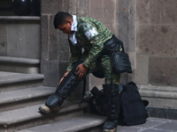 In Mexico City, Mexico, on March 6, 2024, a military police officer is putting on riot gear at the main door of the National Palace to confr...