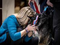 Retired police dog Bane, gets a nuzzle from his handler, Det. Holly McManus of the St. Francis, WI Police Department, after he receives the...