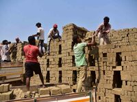 Labourers are working at a brick factory on the outskirts of Guwahati, India, on March 7, 2024. (