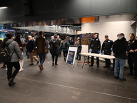 Riders are passing by a police checkpoint at 34th-Penn Station during Thursday evening's rush hour. The National Guard, MTA Police, and New...
