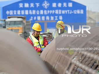Workers are inspecting steel cage piles at the exit of the Tiemengguan tunnel in Bazhou, Xinjiang Province, China, on March 9, 2024. (