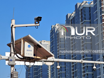 Public security authorities are setting up surveillance equipment on a street in Yantai, East China's Shandong province, on March 9, 2024. O...