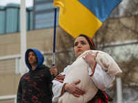 EDMONTON, CANADA - MARCH 9, 2024:
A protester, depicting a Ukrainian woman holding a young child, is seen at Churchill Square during a rally...