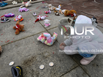 EDMONTON, CANADA - MARCH 9, 2024:
Children's toys and blood, symbolizing the victims of Ukrainian children killed during the Russian aggress...