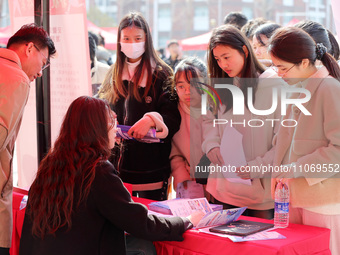 Female college students are looking for jobs at the 2024 Women's Campus job fair in Huaibei, Anhui province, China, on March 12, 2024. (