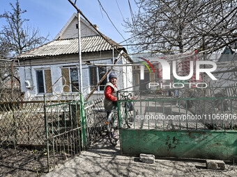 A woman is standing in the yard of her private house in Huliaipole, Zaporizhzhia Region, Ukraine, on March 7, 2024. NO USE RUSSIA. NO USE BE...