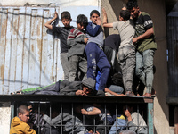 Palestinians are crowding outside a bakery to buy bread in Deir al-Balah in the central Gaza Strip on March 12, 2024, amid ongoing battles b...