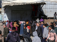 Palestinians are crowding outside a bakery to buy bread in Deir al-Balah in the central Gaza Strip on March 12, 2024, amid ongoing battles b...