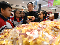 A staff member from the Trade branch of the Market Supervision Bureau in Handan District, Handan City, North China's Hebei province, is inst...