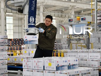 A worker is loading and unloading goods at a smart storage workshop at a hardware manufacturing company in Handan, China, on March 12, 2024....