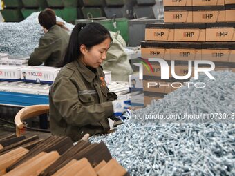 Workers are producing drill tail wire products for export overseas in a digital intelligent production workshop at a hardware manufacturing...