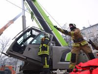 Rescuers are using high-altitude equipment and special tools to search for people under the rubble of a five-story residential building dest...