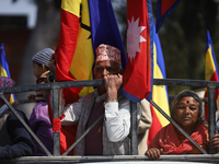 Monarchy supporters in Nepal are riding on the back of a vehicle during a rally organized in Kathmandu, Nepal, on March 14, 2024. Demonstrat...