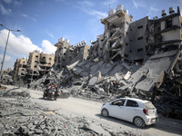 Palestinians are inspecting destroyed residential buildings in Qatari-funded Hamad City, following an Israeli raid, amid the ongoing conflic...