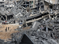 Palestinians are inspecting destroyed residential buildings in Qatari-funded Hamad City, following an Israeli raid, amid the ongoing conflic...