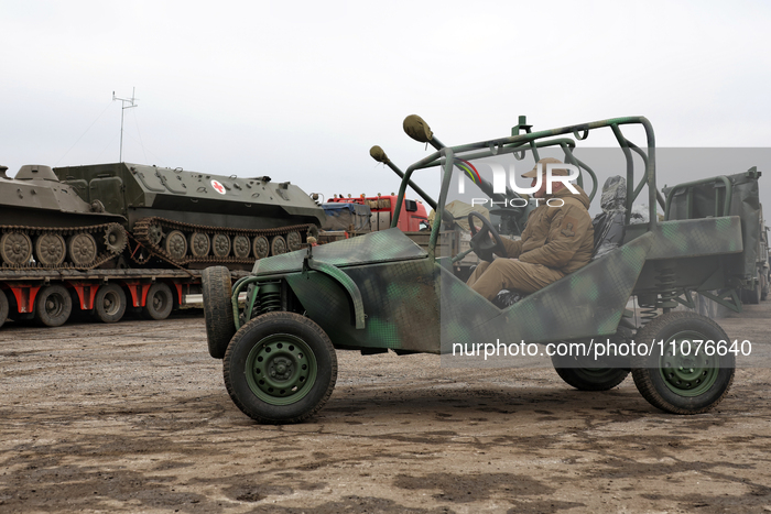 A serviceman is driving a Predator Buggy in Odesa, Ukraine, on March 14, 2024, during an event that provides mobile baths and restored troph...