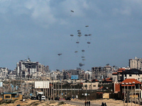 Parachutes are currently attached to parcels of humanitarian aid being airdropped over Gaza City, Palestine, on March 15, 2024, as the confl...
