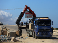 Construction machines are loading stone blocks from Khan Yunis as the construction of the temporary port, which is being built to ensure the...