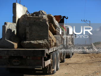 Construction machines are loading stone blocks from Khan Yunis as the construction of the temporary port, which is being built to ensure the...