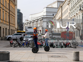 Tourist ride scooters in the landmark Krakowskie Przedmiescia Street in Warsaw, Poland on March 15, 2024. (