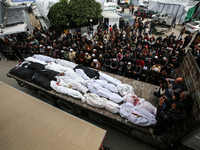 Palestinians are praying over the shrouded bodies of loved ones who were killed during an Israeli bombardment in Deir Al-Balah, in the centr...