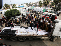 Palestinians are transporting the bodies of their relatives, who were killed in an overnight Israeli strike on the Nuseirat refugee camp, du...