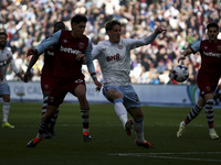 Edson Alvarez of West Ham United is competing with Nicolo Zaniolo of Aston Villa for the ball during the Premier League match between West H...