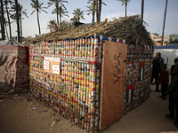 A group of young people are constructing a tent out of canned food cans to draw attention to the displaced Palestinians who have been forced...