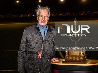Ove Fundin, the former five-time World Speedway Champion, is posing with the Peter Craven Memorial Trophy during the Peter Craven Memorial T...