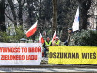 Polish farmers and their supporters hold Polish flags and banners during a protest in front of regional administration office in the centre...