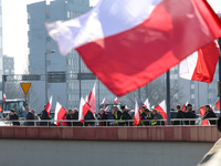Polish farmers and their supporters stand with Polish flags during a protest on Mogilskie roundabout in the centre of Krakow, the capital of...