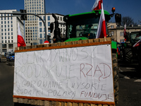 Polish farmers and their supporters drive their tractors in a column to block public roads with Polish flags  and banners during a protest o...