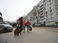 Volunteers from the Ukrainian Red Cross Society are accompanying an elderly woman in Zaporizhzhia, Ukraine, on March 22, 2024. NO USE RUSSIA...