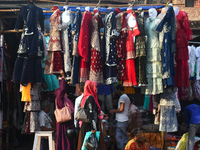 People are buying new dresses for the upcoming Eid al-Fitr festival at a marketplace during the fasting month of Ramadan in Kolkata, India,...