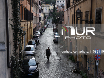A man walks a street in Rome, Italy on March 24, 2024. (
