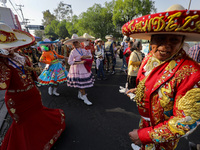 Participants are dressed in traditional Charro suits and are taking part in the Comparsa Faisanes as part of the closing of the Annual Santa...