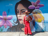 A woman dressed in a traditional Charro suit is participating in the Comparsa Faisanes as part of the closing of the Annual Santa Martha Aca...
