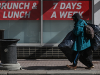 EDMONTON, CANADA - MARCH 24:
A homeless man carrying bags walks on the street in the downtown area of Edmonton, on March 24, 2024, in Edmont...