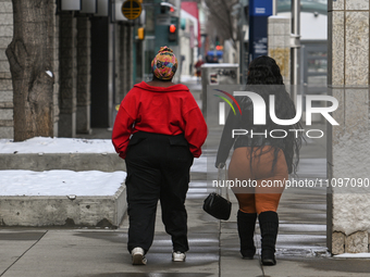 EDMONTON, CANADA - MARCH 23:
Two women are walking in the downtown area of Edmonton, on March 23, 2024, in Edmonton, Alberta, Canada. (